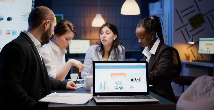 professionals talking over paper on a table